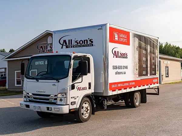 Allison's Manufacturing Ltd garage door truck in front of building